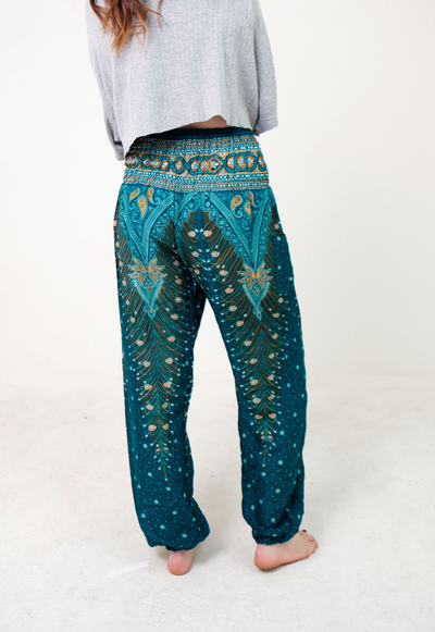 Front-view peacock elephant pants in teal with model and white background-half-size image